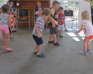 Neighbors | Alexis Bartolomucci.Children listened to the song "Hickory Dickory Dock" while chasing bubbles around the room at the Poland library Baby Brilliant program on Aug. 4.