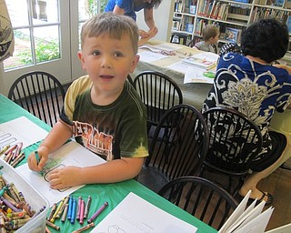 Neighbors | Alexis Bartolomucci.Trevor worked on coloring in his letter "M" maze after story time at the Poland library on Aug. 4.
