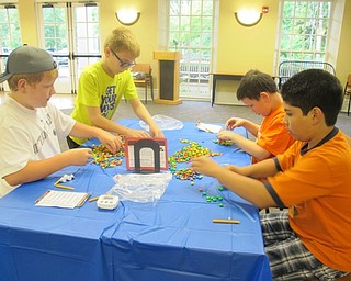Neighbors | Alexis Bartolomucci.Children divided up into teams to see which team could organize the most M&M candies the fastest during the Chocolate Olympics on Aug. 4 at the Poland library.