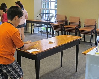 Neighbors | Alexis Bartolomucci.Jacob played a game of hockey with a Ding-Dong at the Poland library Chocolate Olympics event on Aug. 4.