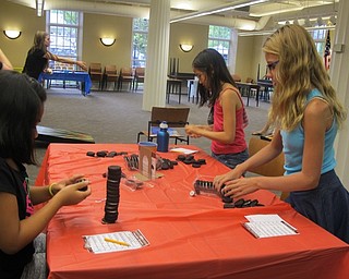 Neighbors | Alexis Bartolomucci.The children took turns stacking cookies to see who could make the highest cookie stack at the Poland library Chocolate Olympics on Aug. 4.