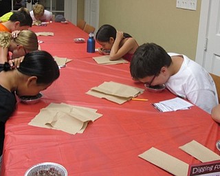 Neighbors | Alexis Bartolomucci.Children went digging for gummy worms in chocolate pudding as the final event at the Chocolate Olympics at the Poland library on Aug. 4.