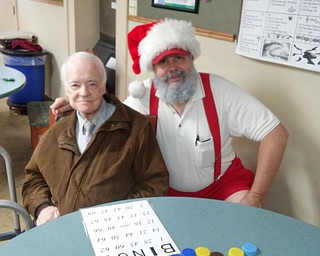 SPECIAL TO THE VINDICATOR
Michael Shuerger Sr., right, dressed as Santa Claus to celebrate Christmas in July with residents like John Dietzel at Ivy Woods Manor in North Lima.