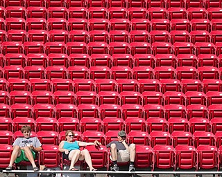 YOUNGSTOWN, OHIO - AUGUST 20, 2016: Three unidentified fans watch practice from the chair back seats, Saturday morning at Stambaugh Stadium. DAVID DERMER | THE VINDICATOR