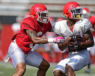 YOUNGSTOWN, OHIO - AUGUST 20, 2016: Isiah Scott #17 (white) is wrapped by by LeRoy Alexander #3 (red) after catching a quick pass during a scrimmage Saturday morning at Stambaugh Stadium. DAVID DERMER | THE VINDICATOR