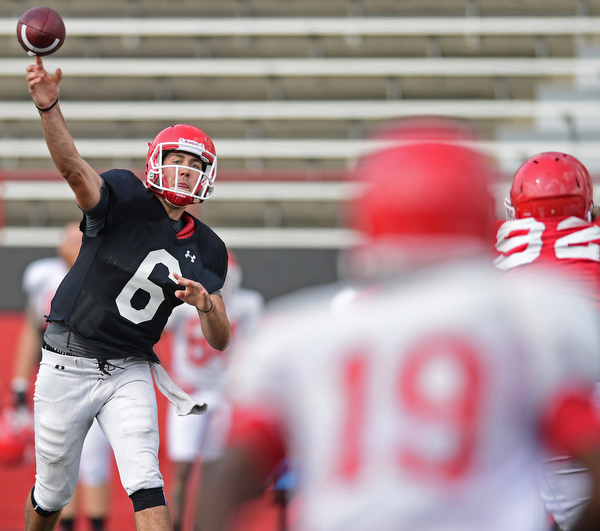 YOUNGSTOWN, OHIO - AUGUST 20, 2016: Hunter Wells #6 (black) throws a pass to Damoun Patterson #19 (white) during a scrimmage Saturday morning at Stambaugh Stadium. DAVID DERMER | THE VINDICATOR