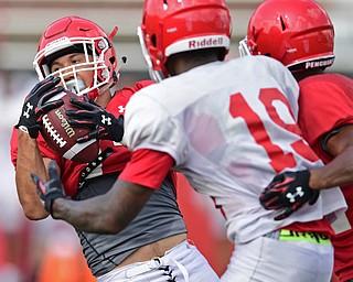 YOUNGSTOWN, OHIO - AUGUST 20, 2016: Billy Nicoe Hurst #17 (red) intercepts a Hunter Wells pass intended for Damoun Patterson #19 (white) during a scrimmage Saturday morning at Stambaugh Stadium. DAVID DERMER | THE VINDICATOR