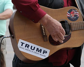 Nikos Frazier | The Vindicator..Kraig Moss plays the guitar outside the James A. Rhodes Arena at The University of Akron before Republican presidential candidate Donald Trump speaks at a campaign rally in Akron, Oh., Saturday, Aug. 20, 2016.