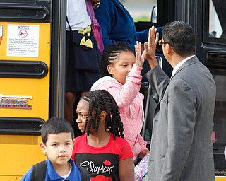        ROBERT K. YOSAY  | THE VINDICATOR.. Krish Mohip...   high fives a student as they arrive at MLK..Krish Mohip, city schools chief executive officer, started his first day of school this morning at Discovery Transition to Careers at Volney.... - -30-...