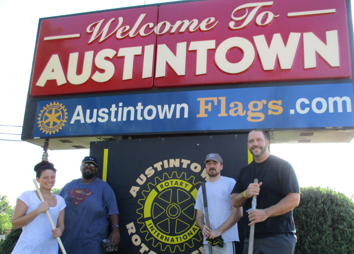 SPECIAL TO THE VINDICATOR
A group of Austintown Rotarians met Aug. 13 at the corner of Raccoon Road and Mahoning Avenue to clean up the Rotary sign as part of the return of American flags along streets in the community. The flags will be featured for Labor Day, 9/11 and Veterans Day before being retired for the winter. Austintown Fitch High School robotics and swim team will help the Rotary by fundraising. Flags can be purchased from any Rotarian, at www.austintownflags.com, or by calling 330-720-0381. Flags cost $30 a year and cover six holidays. Rotarians who participated in the clean up included Stephanie Fabian, left, Jeremy Batchelor, Justin Yost, and president Ed Kalaher. Gary Reel also participated in the program.