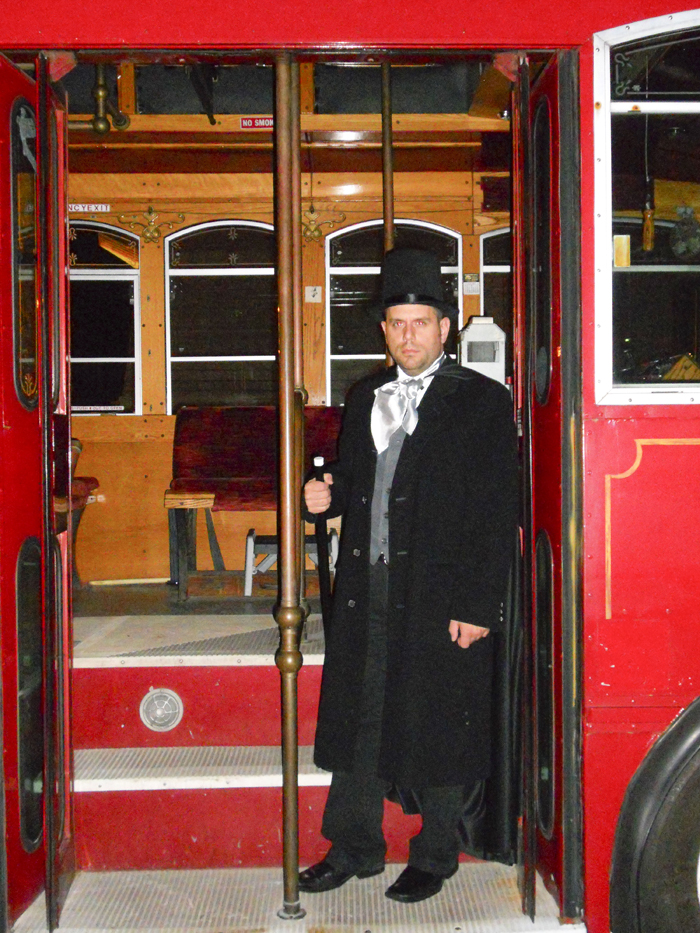 SPECIAL TO THE VINDICATOR
Kevin Schafer, coordinator of ghost tours for Salem Historical Society, is shown by a trolley that ferries tour-goers on Salem Ghost Trolley Tour to cemeteries and other “haunted” areas around Salem. Tour dates are at 8 p.m. Saturday and Sept. 24; 8:30 and 10:30 p.m. Oct. 8 and 6, 8 and 10 p.m. Oct. 15 and 22. Participants will exit the trolley three times at sites. Cost is $15. Salem Ghost Walk takes people around the city and relates Salem’s “haunted” past. The walks, held rain or shine, costs $10 and will take place at 8 p.m. Oct. 14 and 21. Good walking shoes are recommended. A dinner and ghost walk is planned Oct. 28. Available at Salem Historical Society gift shop, 208 S. Broadway Ave., is “The Haunted Salem, Ohio”  by docent Kim Mitchell and tour T-shirts. All tours meet at the Dale Shaffer Research Library meeting room, 239 S. Lundy Ave. Reservations are required for walks and trolley tours. Call 330-205-3923 and leave a message.
