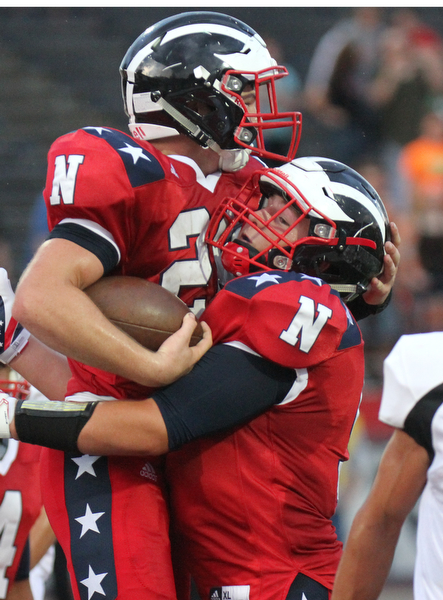 William D. Lewis The VindicatorNiles' Robbie Savin (28), left, gets congrats from Joe Kendall(51) after scoring during first quarter action Thursday Aug 25, 2016 against Niles