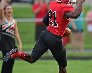 STRUTHERS, OHIO - AUGUST 25, 2016: Regal Reese #21 of Struthers pumps his fist after scoring on a thirty four yard touchdown run in the first quarter of Thursday nights game at Struthers High School. DAVID DERMER | THE VINDICATOR