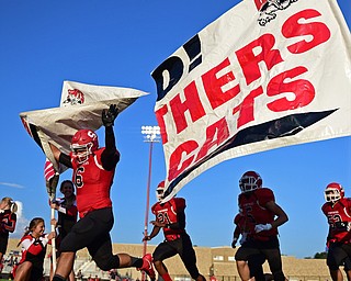STRUTHERS, OHIO - AUGUST 25, 2016: Isaiha Reyes #6 of Struthers runs though a Struthers banner before the start of Thursday nights game at Struthers High School. DAVID DERMER | THE VINDICATOR