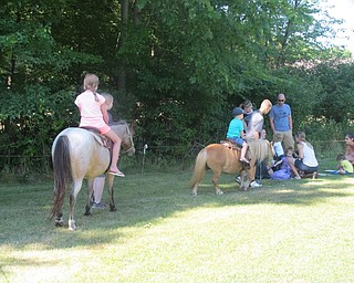Neighbors | Alexis Bartolomucci.There were different sized ponies the children could ride during the program at the Boardman library on July 27.