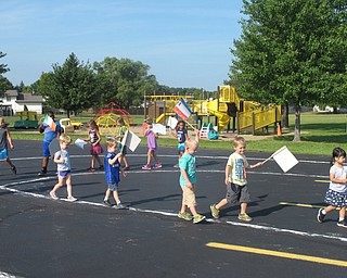 Neighbors | Alexis Bartolomucci.The children at the Austintown Community Church Preschool Childcare Center marched around the parking lot waving their flags during the opening ceremony of their Summer Olympics starting Aug. 5.