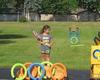 Neighbors | Alexis Bartolomucci.Alexandria Shepas held the flag during the National Anthem before the Summer Olympics began on Aug. 5 at the Austintown Community Church Preschool Childcare Center.