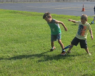 Neighbors | Alexis Bartolomucci.Children participated in a three-legged race to finish off the events for the start of the Summer Olympics on Aug. 5 at the Austintown Community Church Preschool Childcare Center.
