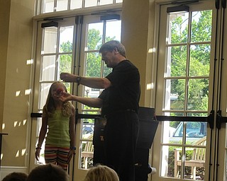 Neighbors | Alexis Bartolomucci.Magician, Jeff Wawrzaszek, brought up volunteers from the audience to help him perform tricks during his magic show at the Poland library on August 3.