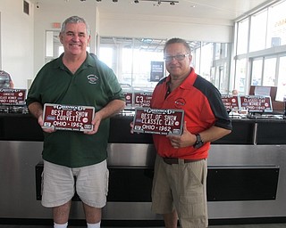 Dan Lyden, Preseident on the Corvette Club, and Mike Sodomora, Vice President, held up two of the prizes winners would receive at the annual Corvette Car Show at Greenwood Chevrolet in Austintown on Aug. 7.