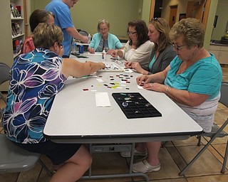Neighbors | Alexis Bartolomucci.Guests who attended the fused glass pendants class at Fellows Riverside Gardens on Aug. 9 picked out pieces of glass to create their own pendants.