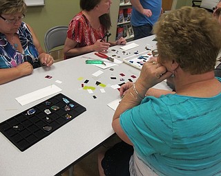 Neighbors | Alexis Bartolomucci.Guests chose from different pieces of glass to create a pendant design they liked best during the fused glass pendant class on Aug. 9 at Fellows Riverside Gardens.