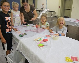 Neighbors | Alexis Bartolomucci.Children worked on making their own cars out of household materials during the Cross the Finish Line event at the Boardman library on Aug. 11.