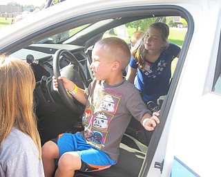 Neighbors | Alexis Bartolomucci.Children at the Safety Village program at Glenwood Middle School on Aug. 11 had the opportunity to explore the inside of a Boardman police car.