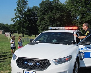 Neighbors | Alexis Bartolomucci.Sgt. Charles Hillman showed the children at the Safety Village program at Glenwood Middle School on Aug. 11 how the lights and sirens looked and sounded.