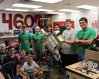 Neighbors | Abby Slanker.Third-year attendees of the annual Robotics Camp, along with their mentors, were in the process of converting an existing robot, built by the high school robotics team, into a t-shirt shooter on Aug. 4.
