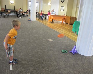 Neighbors | Alexis Bartolomucci.Evan threw a ring for the ring toss game at the Poland library on Aug. 9 for the end of the summer reading program Ice Cream Bash event.