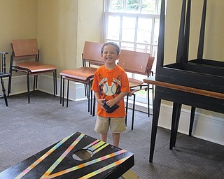 Neighbors | Alexis Bartolomucci.Noah played cornhole during the Ice Cream Bash on Aug. 9 the Poland library hosted to celebrate the end of the summer reading program.