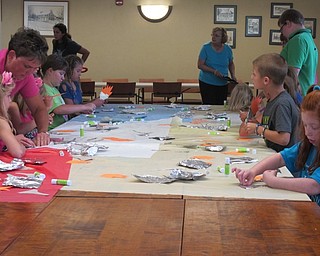 Neighbors | Alexis Bartolomucci.Children made an Olympic torch craft at the Poland library on Aug. 9 while celebrating the end of the summer reading program at the Ice Cream Bash event.