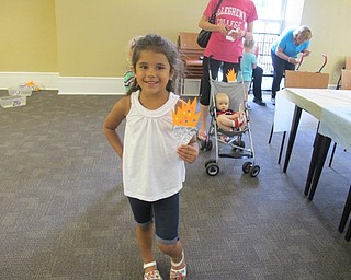 Neighbors | Alexis Bartolomucci.Monica Skurich held up her Olympic torch she made during the Ice Cream Bash at the Poland library on Aug. 9 to celebrate the end of the summer reading program.