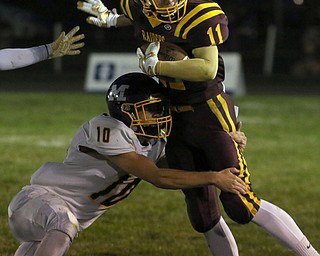  .          ROBERT  K. YOSAY | THE VINDICATOR..South Range #11 Austin Kelly - breaks the tackle of McDonald #10 Josh Celli... Austin made the first down during third quarter action..McDonald at South Range in North Lima..-30-
