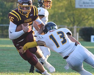  .          ROBERT  K. YOSAY | THE VINDICATOR..McDonald at South Range in North Lima.South Range #15 Seth Morrow breaks a tackle by #13 Dylan Portolese  for a  yard gain during first quarter action - behind them is McDonald #4 Joe Celli.-30-