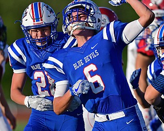 BERLIN CENTER, OHIO - AUGUST 26, 2016: Joey Clegg #6 (right) celebrates with teammate Aaron Posten #28 (left) after a special teams tackle on a kickoff in the first half of their game Friday night at Western Reserve High School. DAVID DERMER | THE VINDICATOR