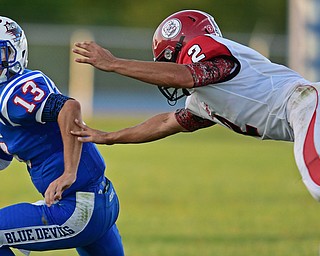 BERLIN CENTER, OHIO - AUGUST 26, 2016: Wyatt Larimer #13 of Western Reserve runs the ball around the corner while avoiding a tackle from Mitch Davidson #2 of Columbiana in the first half of their game Friday night at Western Reserve High School. DAVID DERMER | THE VINDICATOR
