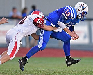 BERLIN CENTER, OHIO - AUGUST 26, 2016: Zach Witherow #50 of Columbiana hits Wyatt Larimer #13 of Western Reserve forcing a fumble resulting in a Columbiana recovery in the first half of their game Friday night at Western Reserve High School. DAVID DERMER | THE VINDICATOR