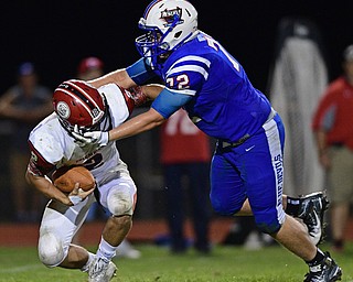 BERLIN CENTER, OHIO - AUGUST 26, 2016: Cody Hilles #72 of Western Reserver grabs the face mask of quarterback Mitch Davidson #2 of Columbiana negating a sack in the second half of their game Friday night at Western Reserve High School. DAVID DERMER | THE VINDICATOR