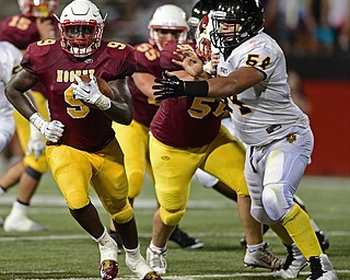 YOUNGSTOWN, OHIO - AUGUST 27, 2016: Jaylen Hewlett #9 of Mooney runs the football away from Kyle McCracken #54 of Cleveland Heights during the first half of their game Saturday night at Stambaugh Stadium. DAVID DERMER | THE VINDICATOR