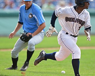 NILES, OHIO - AUGUST 28, 2016: Base runner Silento Sayles runs to first base past relief pitcher Danny Beddes #24 of the Black Bears misplayed the baseball in the sixth inning of Sunday afternoons game at Eastwood Field. DAVID DERMER | THE VINDICATOR