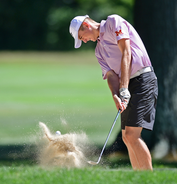 LIBERTY, OHIO - AUGUST 29, 2016: Ken Keller of Mooney chips out of the bunker on the seventh hole Monday afternoon at the Youngstown Country Club during the Ursuline Invitational. DAVID DERMER | THE VINDICATOR