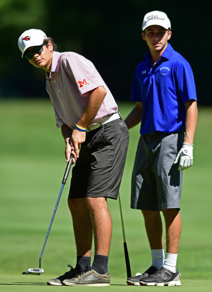 LIBERTY, OHIO - AUGUST 29, 2016: Rebell Strollo of Mooney (left) and Jacob Snyder of Poland (right) watch as Strollo's putt rolls toward the hole on the sixth hole Monday afternoon at the Youngstown Country Club during the Ursuline Invitational. DAVID DERMER | THE VINDICATOR