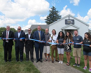 Neighbors | Alexis Bartolomucci.Family members, employees and friends of those at Century 21 Lakeside Realty held the ribbon at the grand opening of the new Austintown location on Aug. 18.