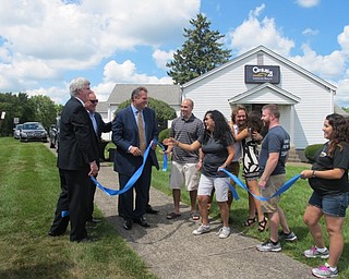 Neighbors | Alexis Bartolomucci.Everyone shook hands and applauded as the ribbon was cut for the grand opening of the Century 21 Lakeside Realty location on Aug. 18 in Austintown.