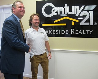 Neighbors | Alexis Bartolomucci.Greg Sexton and George Berick shook hands as they celebrated grand opening of the Lakeside Realty building in Austintown on Aug. 18.