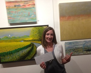 Neighbors | Submitted.Jenna Hudock stood between two of her paintings she had on display at the Trumbull Art Gallery's 52nd annual juried artist exhibition running through the month of August.