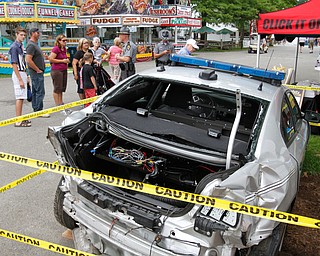        ROBERT K. YOSAY  | THE VINDICATOR..Lt Jerad R sutton of The Canfield OSP.. talks about the most recent patrol car that was hit while working and investigating an accident.- trying to get motorists to slow down and move over... - -30-...