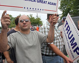 Nikos Frazier | The Vindicator..Two men hold signs supporting Republican presidential nominee Donald J. Trump at the Canfield Fair as Vice President Joe Biden makes a quick stop for lunch.